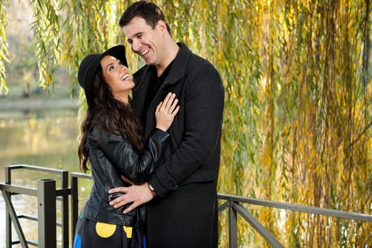 Beautiful smiling couple walking in autumn park