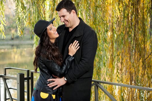 Beautiful smiling couple walking in autumn park