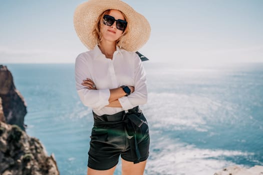 Happy girl doing yoga with laptop working at the beach. beautiful and calm business woman sitting with a laptop in a summer cafe in the lotus position meditating and relaxing. freelance girl remote work beach paradise