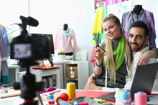 Fashion designers create new clothes in studio. Couple of stylists in sewing studio concept