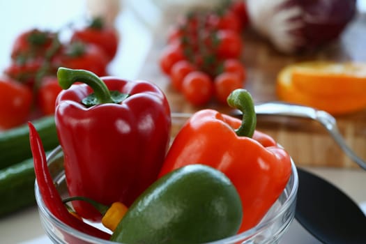 Fresh juicy vegetables and fruits in kitchen on table. Organic healthy wholesome vegetable food concept