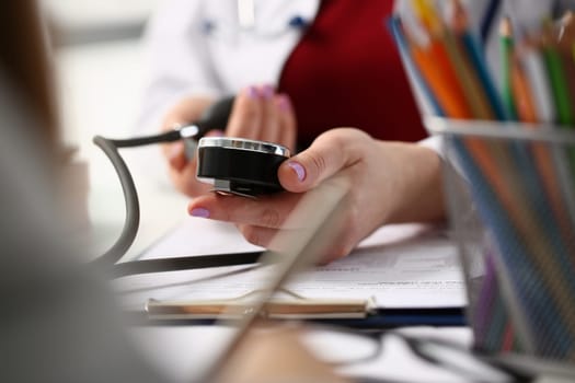 Doctor checks patient blood pressure in clinic. Measurement and control of blood pressure concept