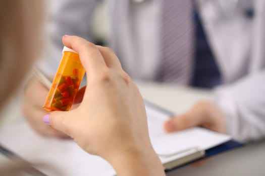 Closeup of patient hands with medical pills and doctor. Medical drugs and treatment of diseases concept