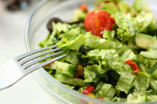 Delicious vitamin fresh salad with fresh lettuce tomatoes and cucumbers. Vegetarian salads concept