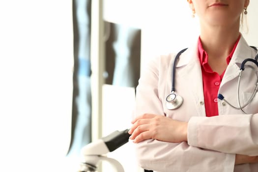 Silhouette of doctor with crossed arms in clinic. Health insurance and services concept