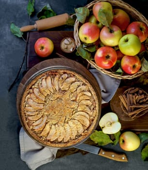 Home made apple pie with fresh fruits on a wooden table