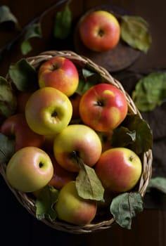 Top view on a ripe apples on a wooden table in basket