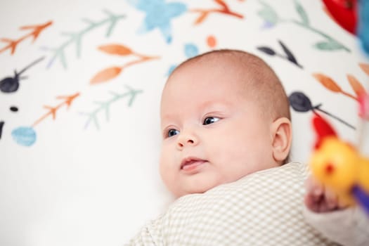 happy cute newborn baby in crib at home