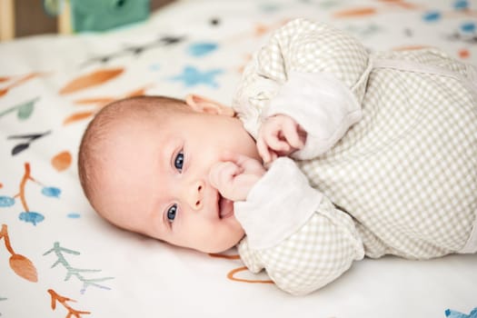 happy cute newborn baby in crib at home