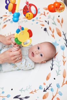 Baby massage. Mother doing gymnastics with her newborn child at home