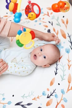 Baby massage. Mother doing gymnastics with her newborn child for healthy.