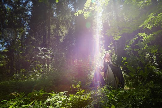 Beautiful seductive dryad. Pagan spirit of forest. Portrait of beautiful dryad. Fairy who loves nature in beautiful green summer forest. Concept of environmental friendliness and caring for nature