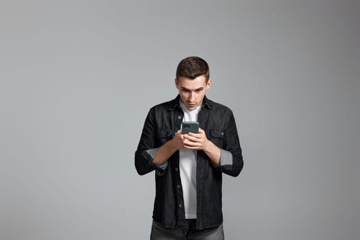 surprised man in shirt messaging with mobile cell phone