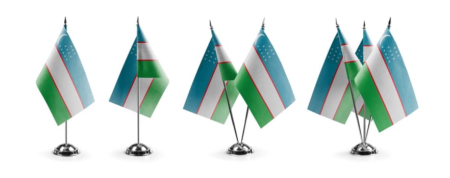 Small national flags of the Uzbekistan on a white background.