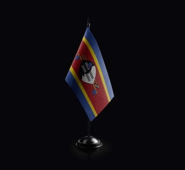 Small national flag of the Swaziland on a black background.