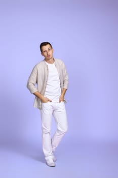 surprised caucasian man in casual shirt posing on pastel purple background. Full length photo