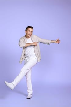 handsome happy man walks isolated on violet background.