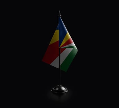 Small national flag of the Seychelles on a black background.