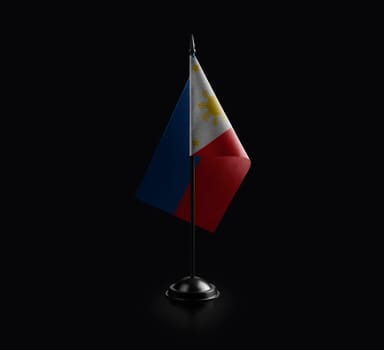 Small national flag of the Philippines on a black background.