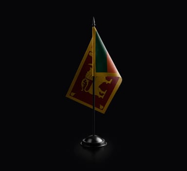 Small national flag of the Sri Lanka on a black background.