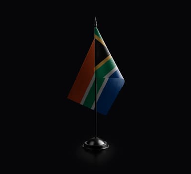 Small national flag of the South Africa on a black background.