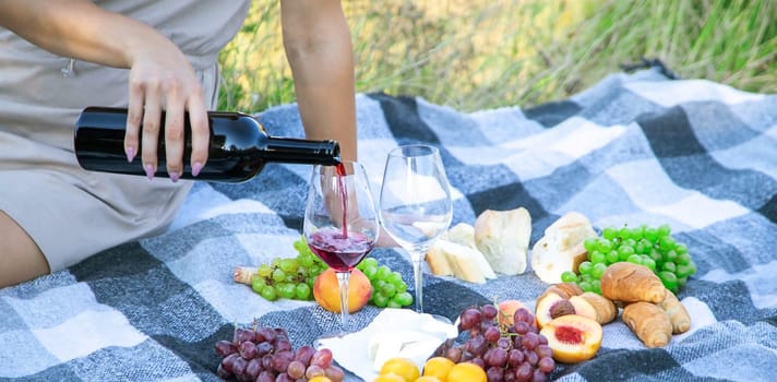 picnic in nature, girl pouring wine, couple in love. nature. selective focus