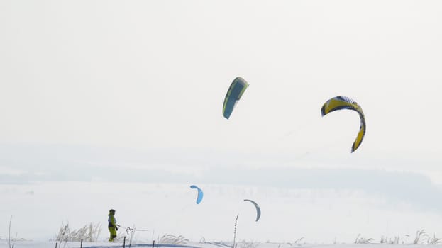 man is snowkiting in the field.