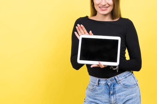 Smart intelligent caucasian young woman student using digital tablet isolated on yellow background