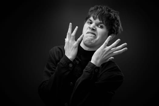 portrait of crazy young man with awesome hairdo grimacing . black and white