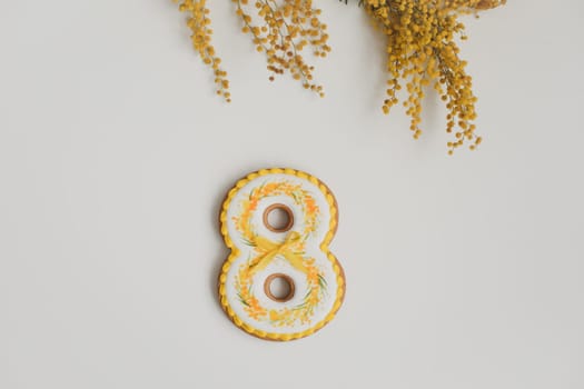 March 8 women holiday. Number eight on a white background and yellow mimosa