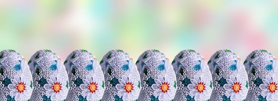 Easter eggs set in a row on a fuzzy colored background. A decoration for the Easter world that allows you to add your own graphic additions.