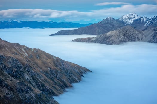 Stelvio pass, mountain dramatic landscape at dawn above mist, Northern Italy