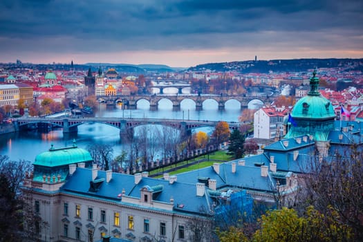 Panoramic view over the cityscape of Prague and Vltava river at dramatic evening, Czech Republic