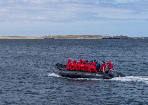 Port Stanley - Falkland Islands: 31 January 2023: Passengers from Silversea Antarctic cruise taking RIB boat into Stanley