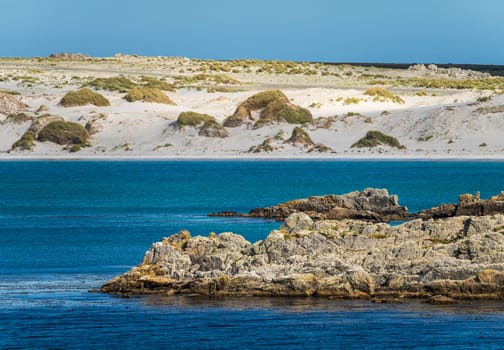 Sandy beaches and rocks when approaching the port of Stanley on the Falkland Islands from the ocean