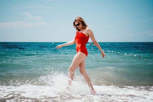 Pretty young blonde woman walking on the beach in summer, having fun, walks carefree on the seaside . Portrait beautiful young woman relax smile around beach sea ocean in holiday vacation travel trip.