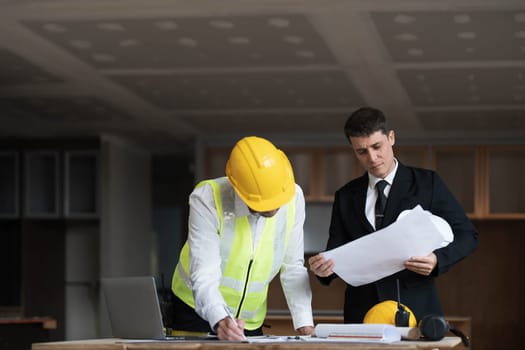 Diverse Team of Specialists Use Laptop on Construction Site. Real Estate Building Project with Engineer Investor and Businessman Checking Area, working on Civil Engineering, Discussing Strategy Plan..