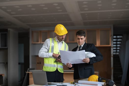 Diverse Team of Specialists Use Laptop on Construction Site. Real Estate Building Project with Engineer Investor and Businessman Checking Area, working on Civil Engineering, Discussing Strategy Plan..