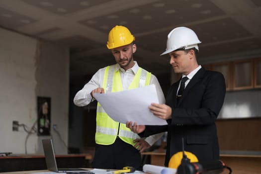 Diverse Team of Specialists Use Laptop on Construction Site. Real Estate Building Project with Engineer Investor and Businessman Checking Area, working on Civil Engineering, Discussing Strategy Plan..