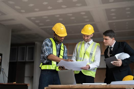 Diverse Team of Specialists Use Laptop on Construction Site. Real Estate Building Project with Engineer Investor and Businessman Checking Area, working on Civil Engineering, Discussing Strategy Plan..