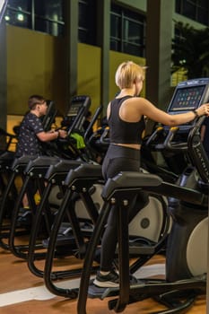 Elliptical trainer young training health, In the afternoon fitness gym for cross healthy coach, class elliptical. Cardio lifestyle background, trainer