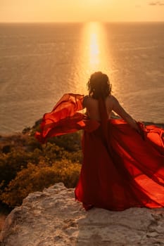 Woman in red dress, fashion model in evening dress, soaring in the street, sunset.