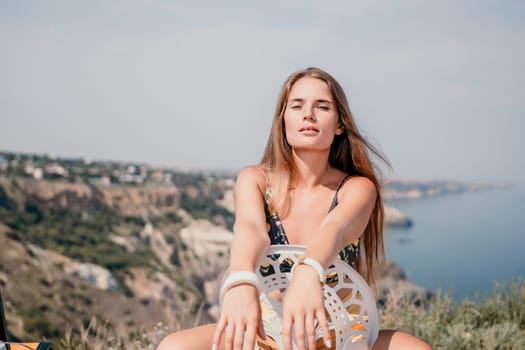 Happy woman portrait in cafe. Boho chic fashion style. Outdoor photo of young happy woman with long hair, sunny weather outdoors sitting in modern cafe