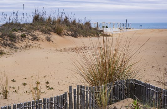 View of the deserted beach and the endless sea on a cloudy day.