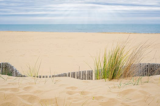 View of the deserted beach and the endless sea on a cloudy day.
