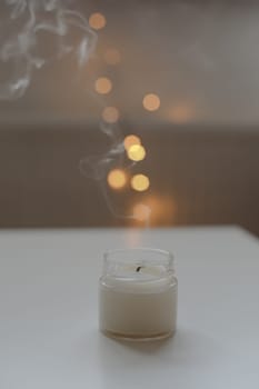 Cozy home composition with candle on a blurred background.