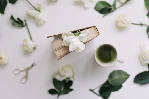 floral composition with white roses on a white background, top view, flatlay