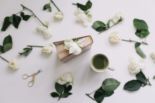 floral composition with white roses on a white background, top view, flatlay