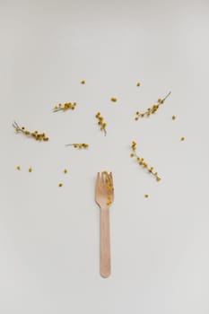 Cutlery with flowers on white textured background. Sustainable lifestyle, no plastic concept, zero waste