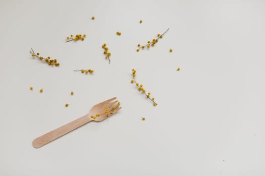 Cutlery with flowers on white textured background. Sustainable lifestyle, no plastic concept, zero waste